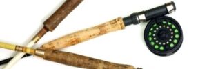 Three fly fishing rods with reels are arranged on a white background, handles pointing in different directions.